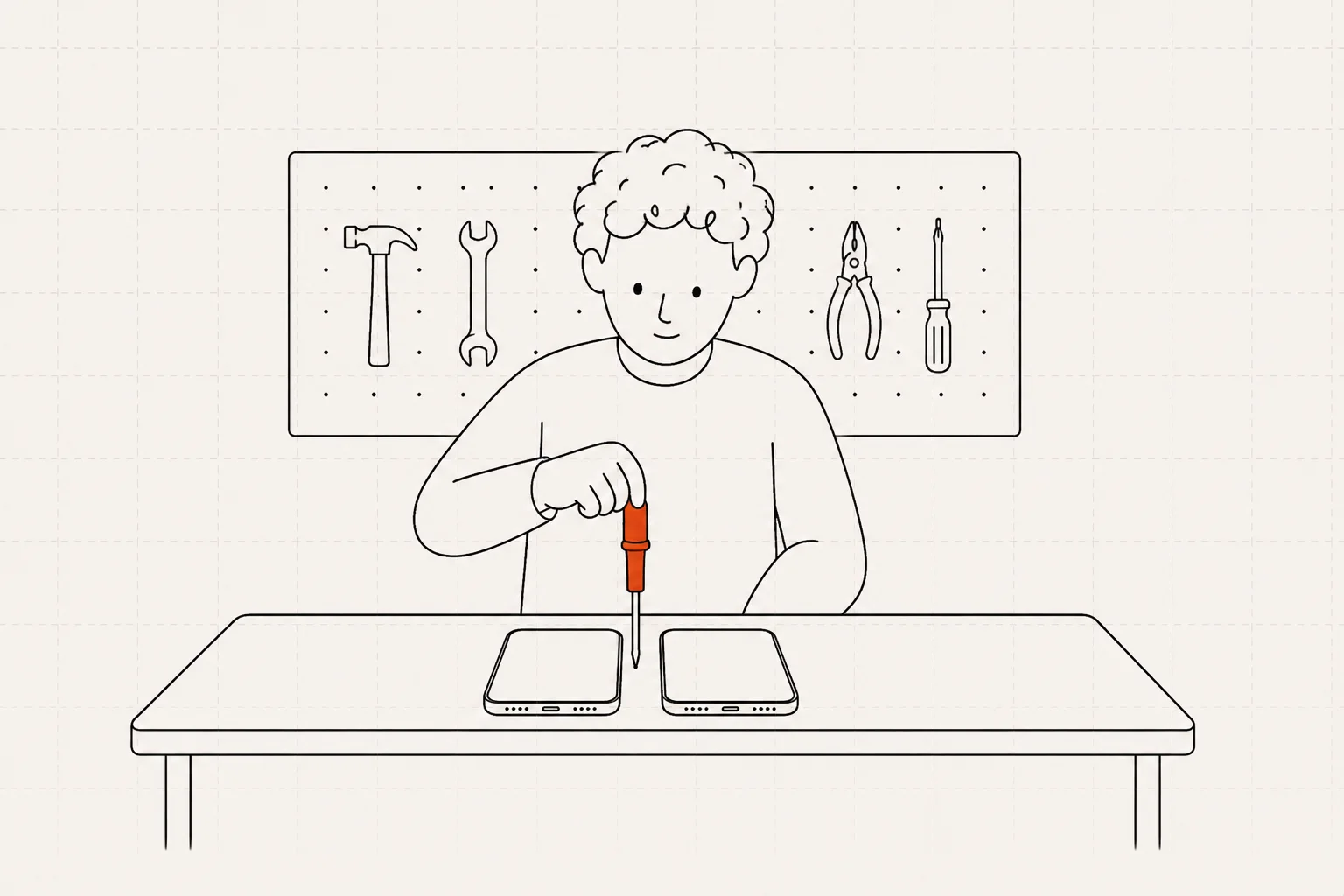 A person at a workbench opening two phones with a screwdriver.